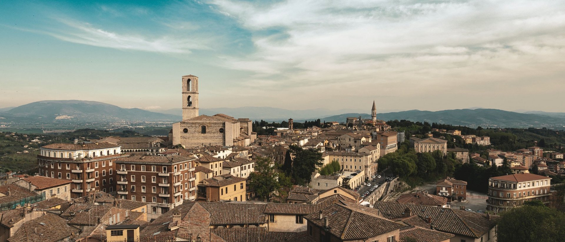 Basilica of Saint Francis of Assisi Panoramic view of the town with historic buildings and bell towers under a partly cloudy sky