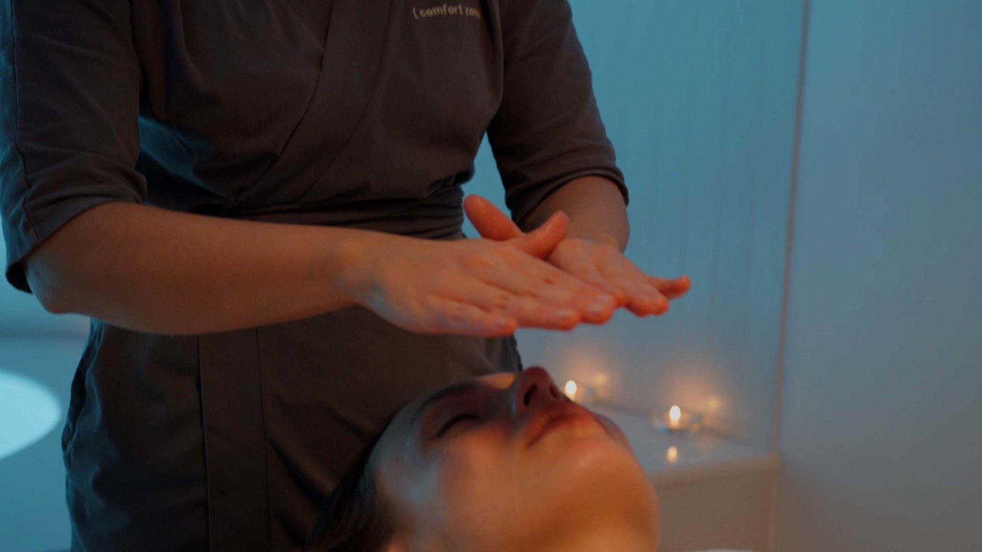 A holiday near Assisi: activities galore Practitioner holding hands above a woman's face in a spa